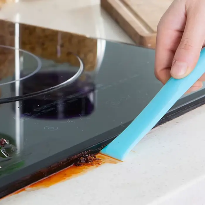 Grattoir de nettoyage double extrémité pour cuisinière à gaz